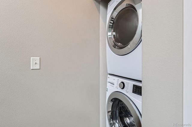 laundry room featuring stacked washer and dryer and laundry area