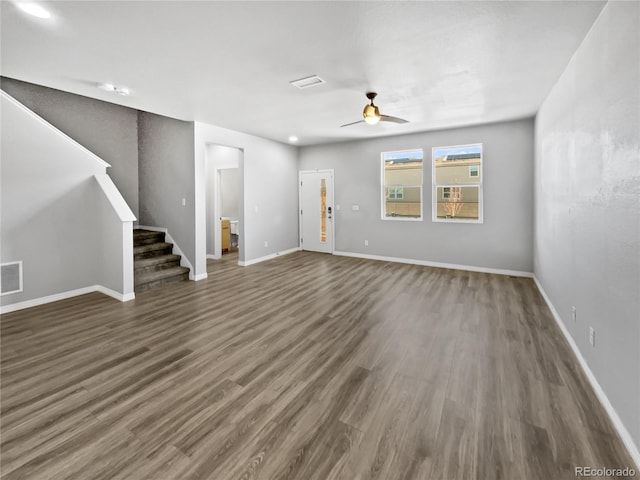 unfurnished living room featuring dark hardwood / wood-style flooring and ceiling fan