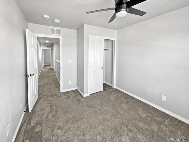 unfurnished bedroom with carpet floors, a closet, and ceiling fan