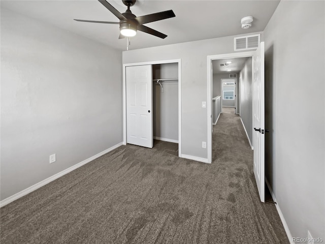 unfurnished bedroom featuring a closet, ceiling fan, and dark colored carpet