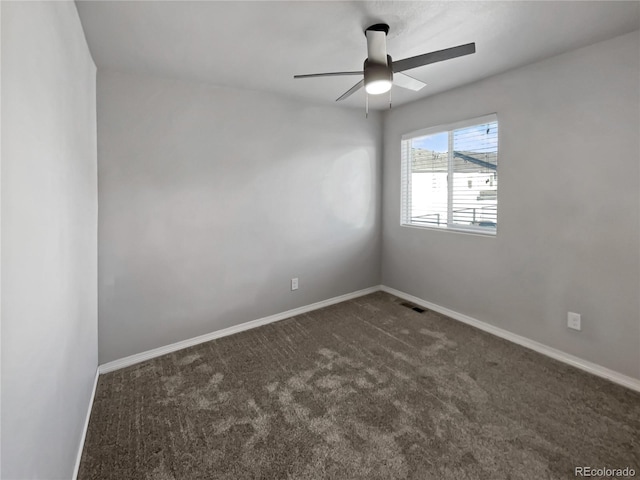 carpeted spare room featuring ceiling fan