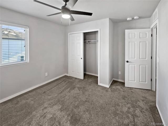 unfurnished bedroom featuring ceiling fan, dark carpet, and a closet