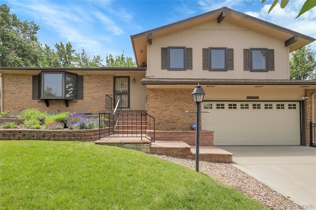 11936 E Oregon Cir, Aurora, CO 80012 - split level home featuring an attached garage, brick siding, a front yard, and driveway