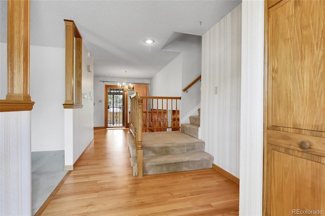 11936 E Oregon Cir, Aurora, CO 80012 - staircase with a chandelier, wood finished floors, baseboards, a textured ceiling, and recessed lighting
