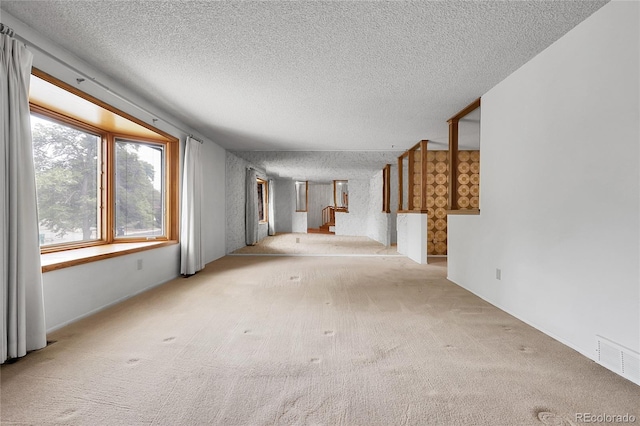 11936 E Oregon Cir, Aurora, CO 80012 - unfurnished living room with carpet floors and a textured ceiling