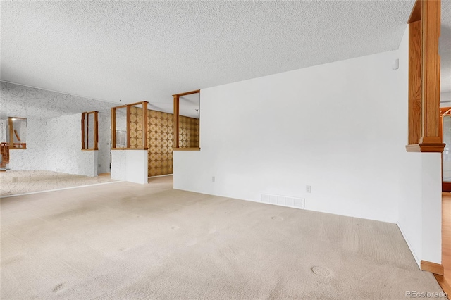 11936 E Oregon Cir, Aurora, CO 80012 - unfurnished living room featuring carpet and a textured ceiling