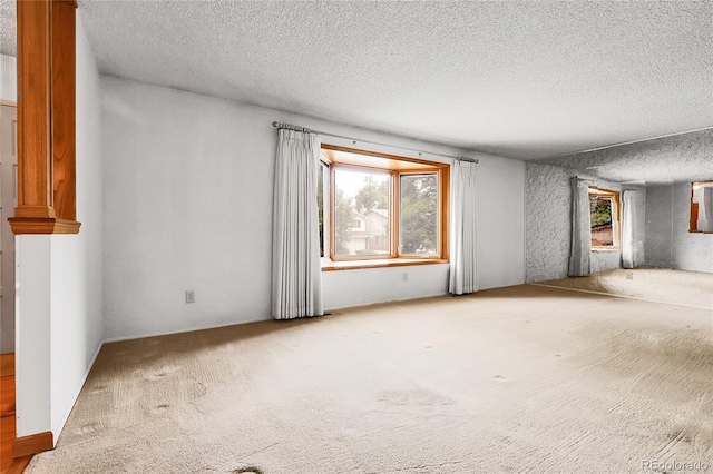 11936 E Oregon Cir, Aurora, CO 80012 - carpeted empty room featuring a textured ceiling and plenty of natural light