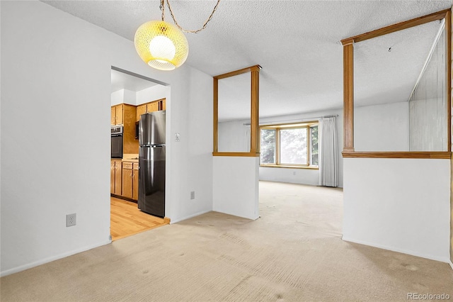 11936 E Oregon Cir, Aurora, CO 80012 - empty room featuring light colored carpet and a textured ceiling