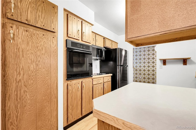 11936 E Oregon Cir, Aurora, CO 80012 - kitchen with black oven, freestanding refrigerator, light countertops, and stainless steel microwave