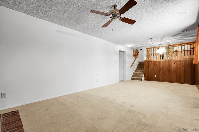 11936 E Oregon Cir, Aurora, CO 80012 - unfurnished living room with stairway, a ceiling fan, light carpet, a textured ceiling, and baseboards