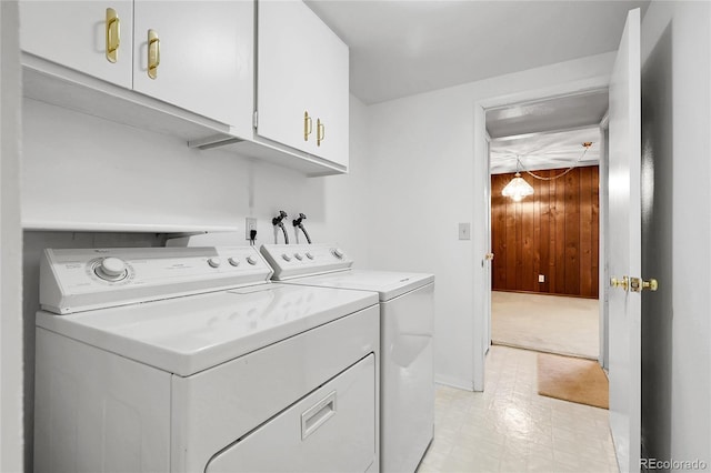 11936 E Oregon Cir, Aurora, CO 80012 - washroom featuring independent washer and dryer, cabinet space, and wood walls