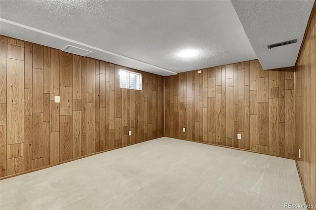 11936 E Oregon Cir, Aurora, CO 80012 - below grade area featuring a textured ceiling, wooden walls, and carpet flooring