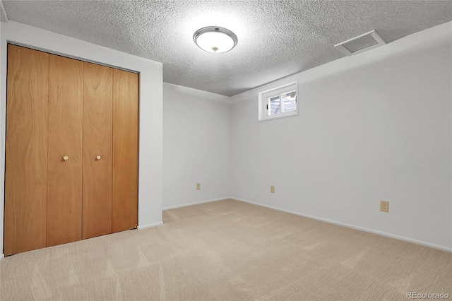 11936 E Oregon Cir, Aurora, CO 80012 - unfurnished bedroom featuring a textured ceiling, carpet floors, a closet, and baseboards