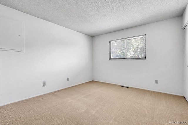 11936 E Oregon Cir, Aurora, CO 80012 - spare room featuring light carpet, a textured ceiling, and baseboards
