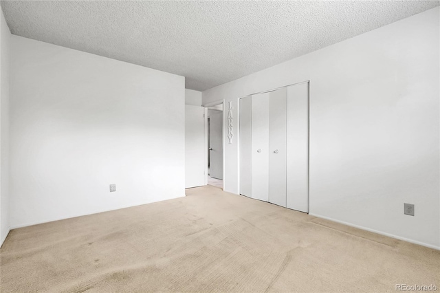 11936 E Oregon Cir, Aurora, CO 80012 - unfurnished bedroom featuring light colored carpet, a closet, and a textured ceiling