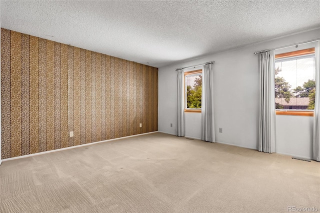 11936 E Oregon Cir, Aurora, CO 80012 - empty room featuring healthy amount of natural light, carpet floors, a textured ceiling, and wallpapered walls