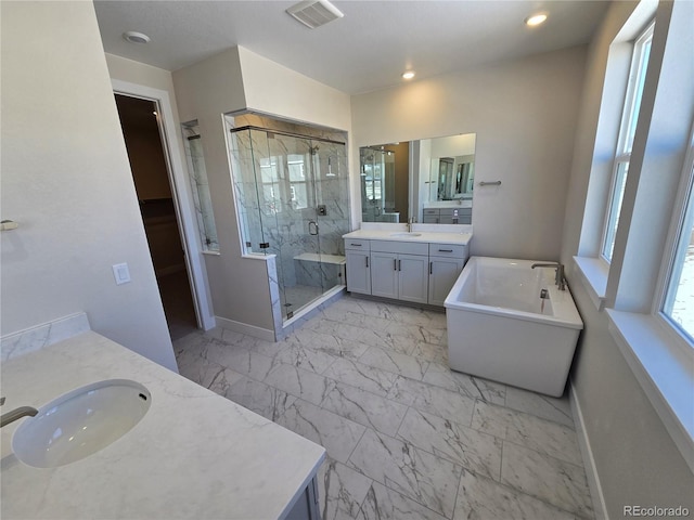 bathroom featuring vanity and shower with separate bathtub