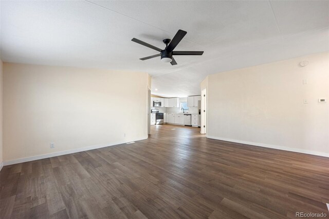 63560 Huckleberry Rd, Fowler, CO 81039 - unfurnished living room with baseboards, a ceiling fan, dark wood finished floors, and vaulted ceiling