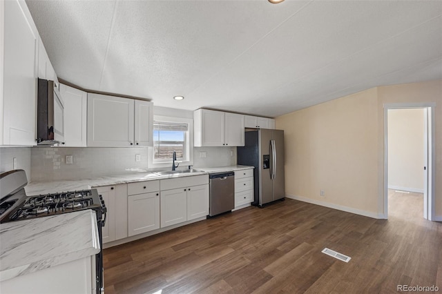 63560 Huckleberry Rd, Fowler, CO 81039 - kitchen featuring stainless steel appliances, a sink, dark wood-style flooring, backsplash, and white cabinets