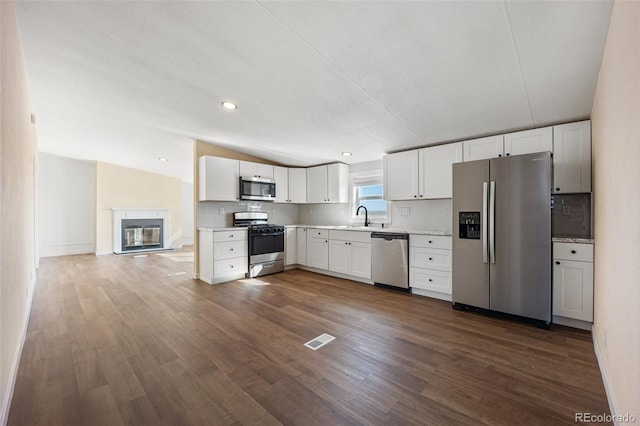 63560 Huckleberry Rd, Fowler, CO 81039 - kitchen featuring stainless steel appliances, a sink, light countertops, dark wood finished floors, and white cabinets