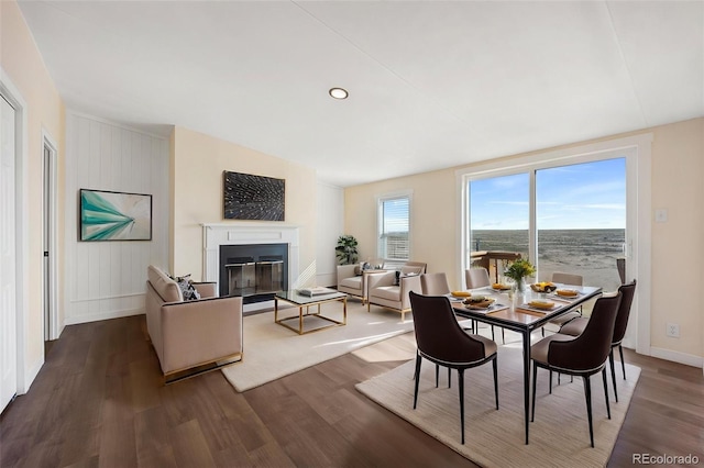 63560 Huckleberry Rd, Fowler, CO 81039 - dining room with dark wood-type flooring, a glass covered fireplace, and baseboards
