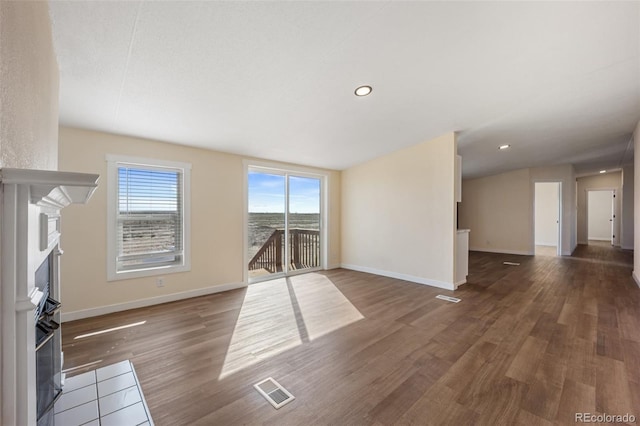 63560 Huckleberry Rd, Fowler, CO 81039 - unfurnished living room with a fireplace with flush hearth, wood finished floors, baseboards, and recessed lighting