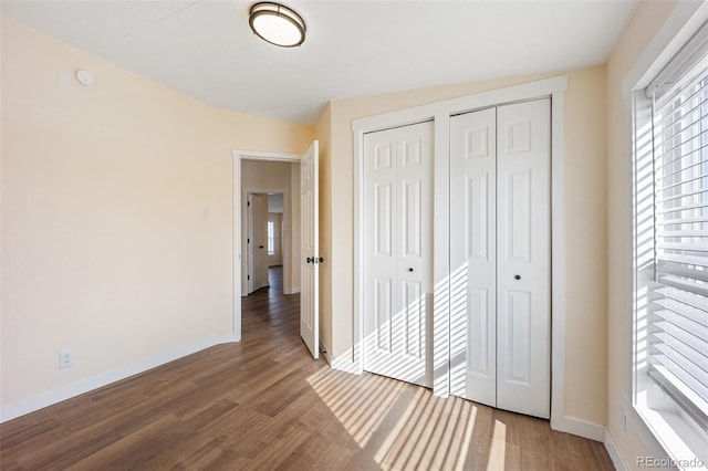 63560 Huckleberry Rd, Fowler, CO 81039 - unfurnished bedroom featuring wood finished floors, baseboards, and multiple closets