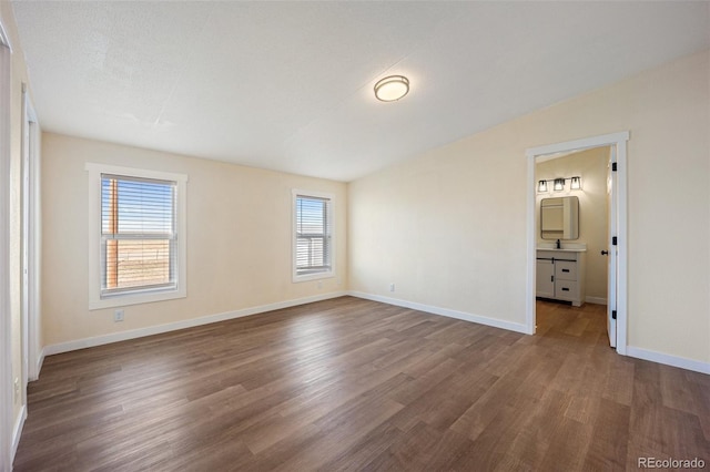 63560 Huckleberry Rd, Fowler, CO 81039 - unfurnished bedroom featuring wood finished floors, baseboards, and ensuite bath