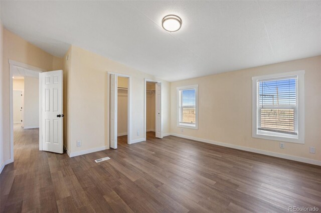 63560 Huckleberry Rd, Fowler, CO 81039 - unfurnished bedroom with dark wood-style flooring, baseboards, and lofted ceiling
