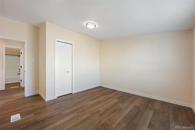 63560 Huckleberry Rd, Fowler, CO 81039 - unfurnished bedroom featuring dark wood-style flooring, baseboards, and a closet