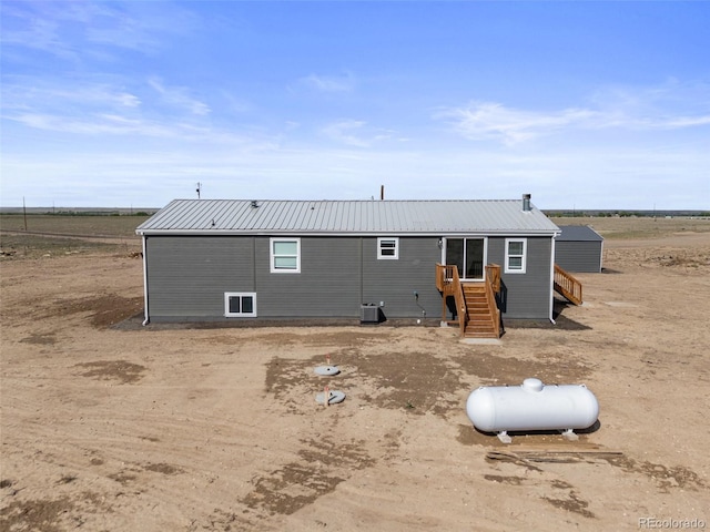 63560 Huckleberry Rd, Fowler, CO 81039 - rear view of house with metal roof and central AC unit