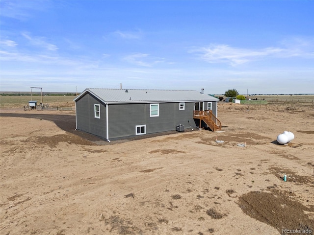 63560 Huckleberry Rd, Fowler, CO 81039 - back of house with metal roof, central AC unit, and a view of countryside