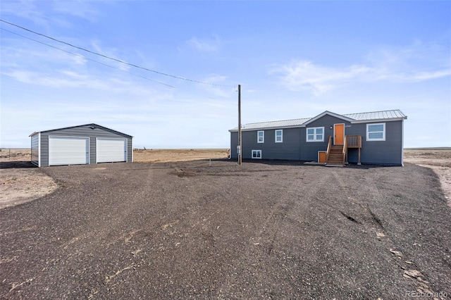 63560 Huckleberry Rd, Fowler, CO 81039 - manufactured / mobile home featuring an outbuilding, a garage, metal roof, and driveway