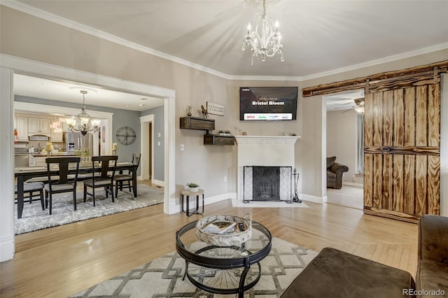 1510 S Cascade Ave, Colorado Springs, CO 80905 - living room with a chandelier, ornamental molding, a fireplace with flush hearth, and light wood-type flooring