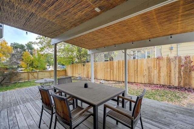 1510 S Cascade Ave, Colorado Springs, CO 80905 - wooden deck with outdoor dining area and a fenced backyard