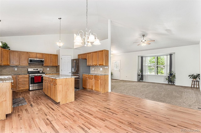 9650 Raven St, Firestone, CO 80504 - kitchen with appliances with stainless steel finishes, open floor plan, light wood finished floors, tasteful backsplash, and high vaulted ceiling
