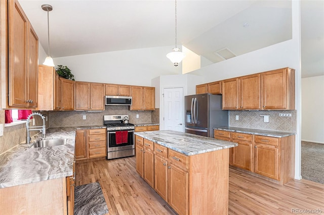 9650 Raven St, Firestone, CO 80504 - kitchen with stainless steel appliances, a sink, light wood finished floors, a kitchen island, and high vaulted ceiling