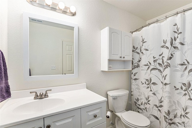 9650 Raven St, Firestone, CO 80504 - bathroom featuring vanity, toilet, a textured wall, and a shower with curtain