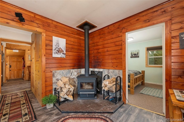 479 County Road 465, Grand Lake, CO 80447 - detailed view of wood finished floors, a wood stove, baseboards, and wooden walls