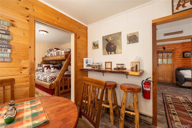 479 County Road 465, Grand Lake, CO 80447 - dining room featuring ornamental molding, wooden walls, a bar, and wood finished floors