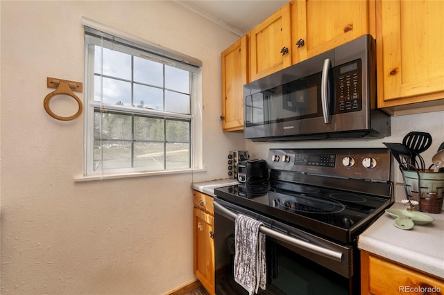 479 County Road 465, Grand Lake, CO 80447 - kitchen featuring appliances with stainless steel finishes, light countertops, and ornamental molding