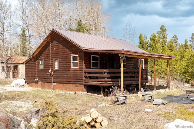 479 County Road 465, Grand Lake, CO 80447 - view of property exterior with metal roof, a deck, and log siding