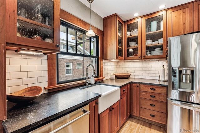 3145 W 31st Ave, Denver, CO 80211 - kitchen featuring stainless steel appliances, light wood-type flooring, brown cabinetry, and recessed lighting