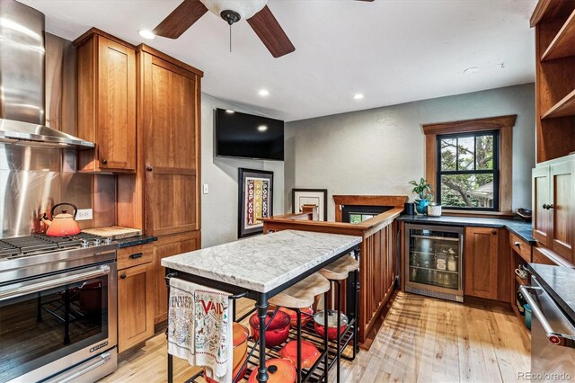 3145 W 31st Ave, Denver, CO 80211 - kitchen with wall chimney exhaust hood, wine cooler, brown cabinets, and recessed lighting
