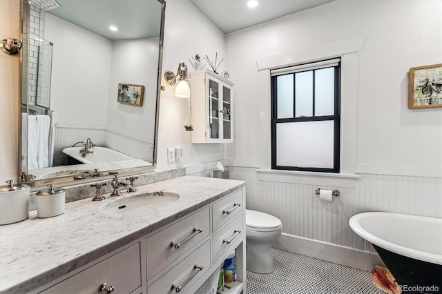 3145 W 31st Ave, Denver, CO 80211 - bathroom featuring a wainscoted wall, vanity, a freestanding tub, and tile patterned flooring
