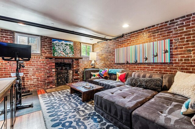3145 W 31st Ave, Denver, CO 80211 - living room featuring wood-type flooring, brick wall, and a fireplace