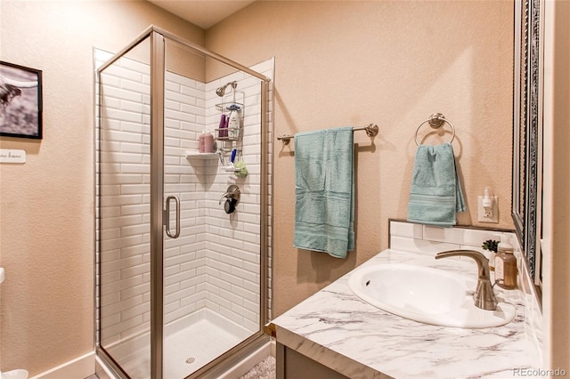 bathroom with an enclosed shower and vanity