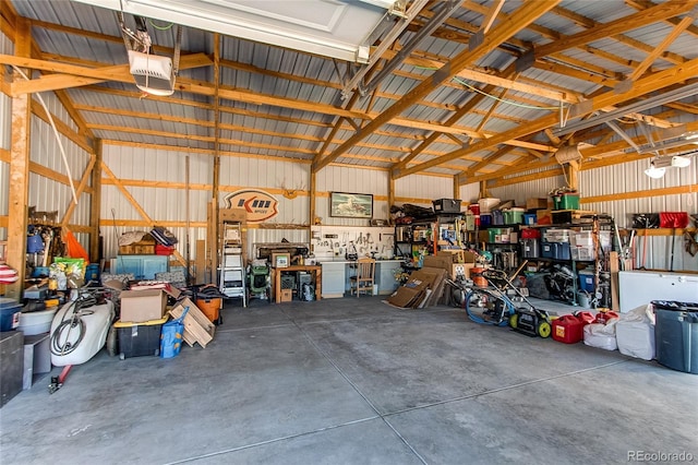 garage with a garage door opener and a workshop area