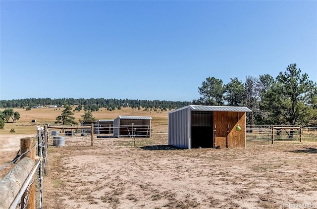 view of horse barn featuring a rural view