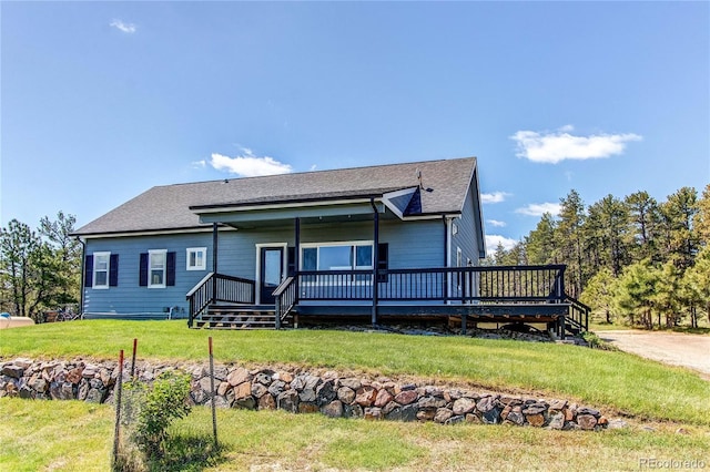 18050 Wedemeyer Rd, Kiowa, CO 80117 - view of front of property with a front lawn, a wooden deck, and roof with shingles